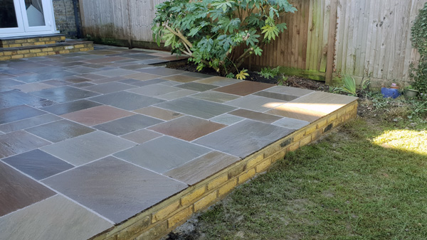 raised stone slab garden patio constructed by Bizzy in the Garden
